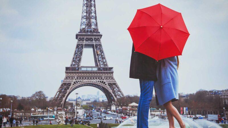 A couple in front of the Eiffel Tower, Paris