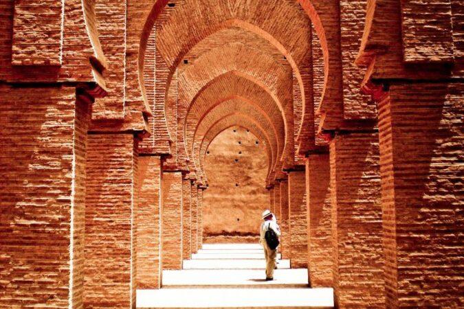 A man exploring an old mosque in Morocco