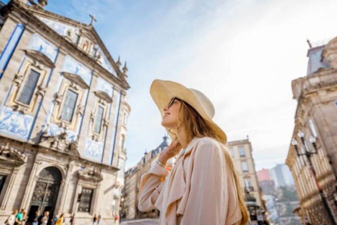 A woman on a her Portugal vacation enjoying a city tour of Lisbon