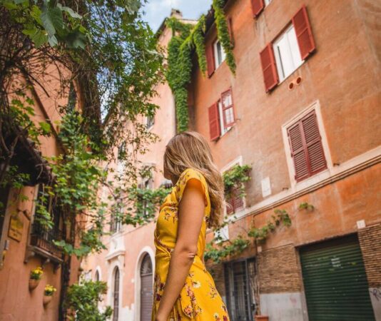 A young woman in a yellow dress enjoying her tour to Italy