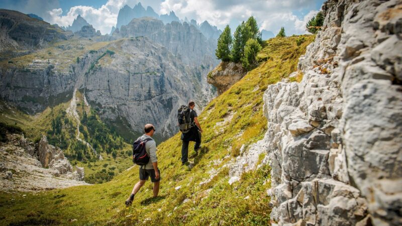 Two men are hiking in Dolomites, Italy