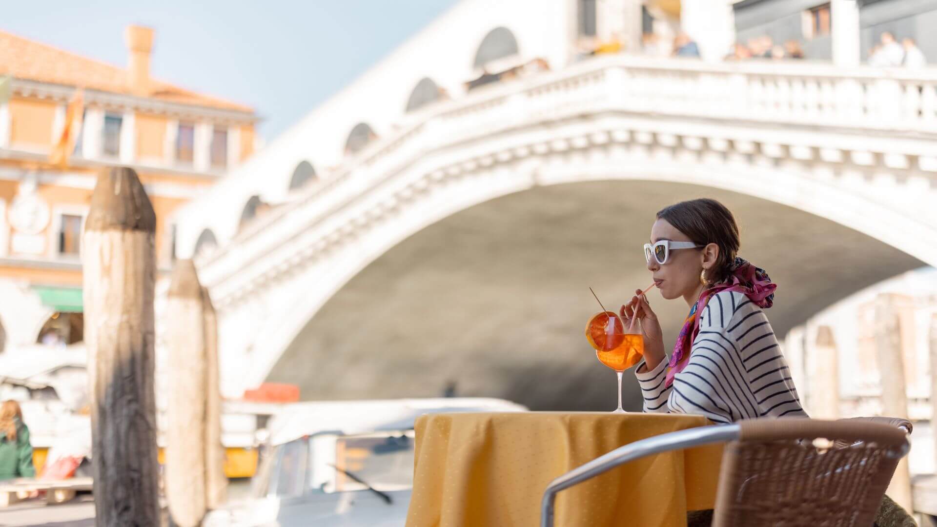 A woman drinking a cocktail in Venice