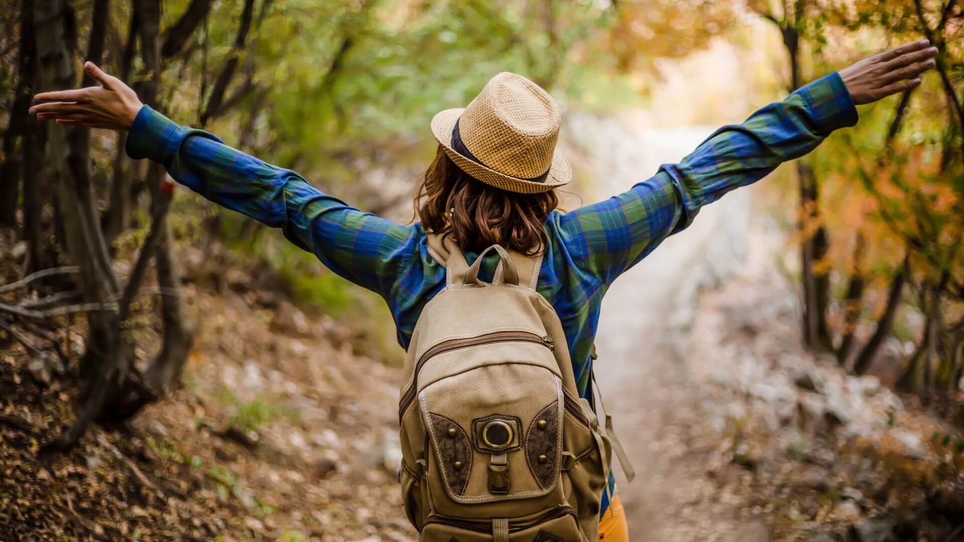 A woman wnjoying herself on a hike during her solo vacation