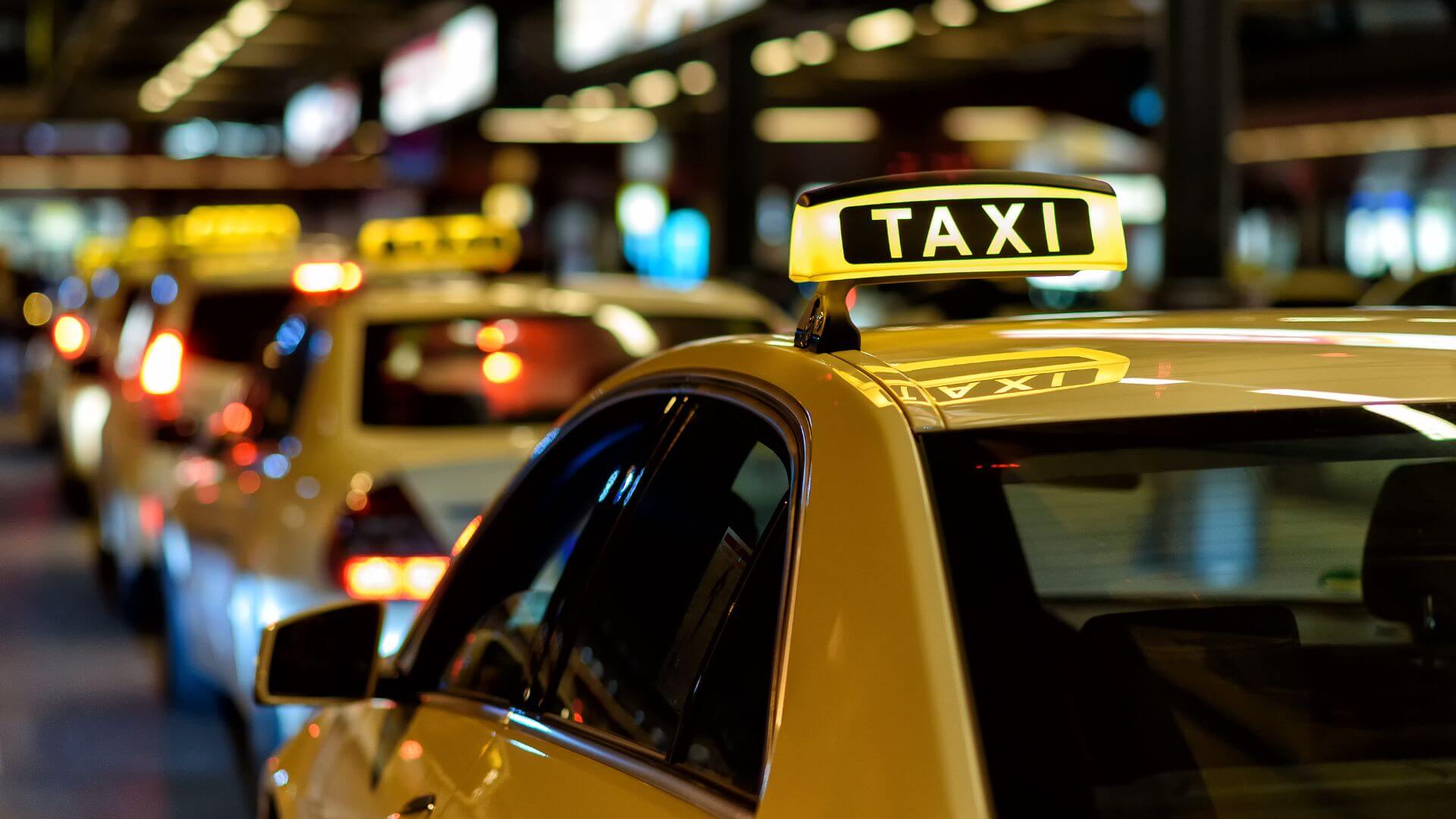 A close up of a taxi at night