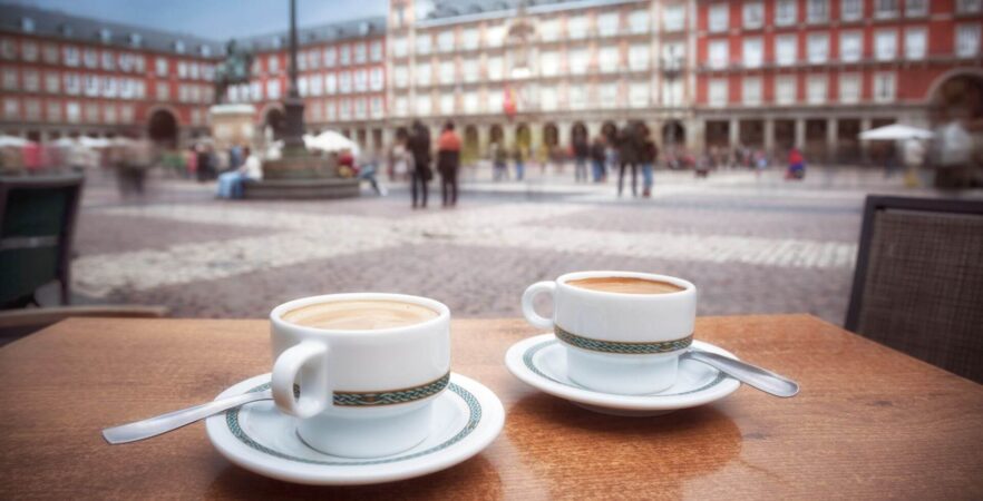 two cups of coffee on a table in a cafe on plazza de mayor, a must-see place on a tour to Spain