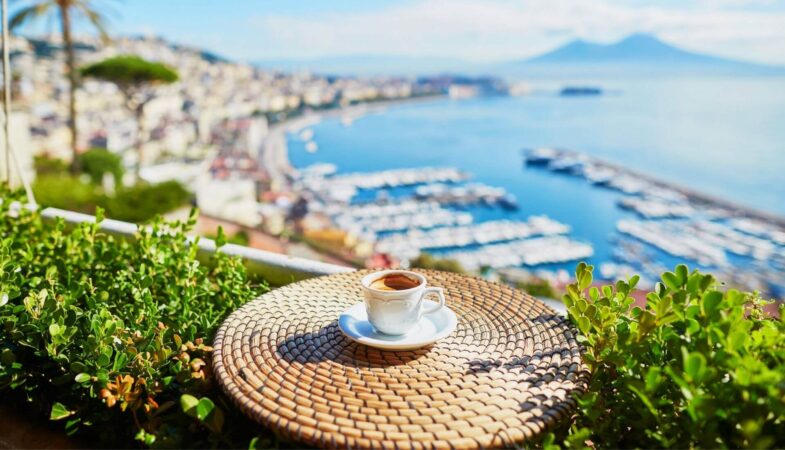 Cup of cofee on a parapet overlooking Naples